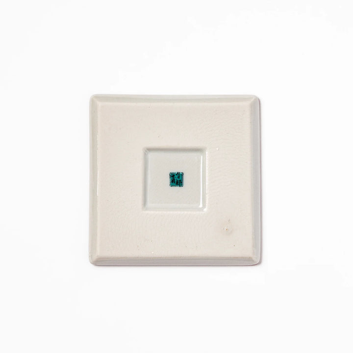 Square Japanese ceramic coaster with red and white checkered pattern decorated with plum blossom motifs, adding traditional charm to any dining table.