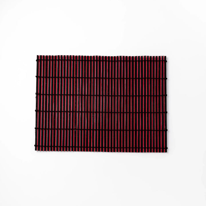 Red and black bamboo table mat with tightly spaced slats and black cord binding, adding bold color and texture to modern Japanese table settings.