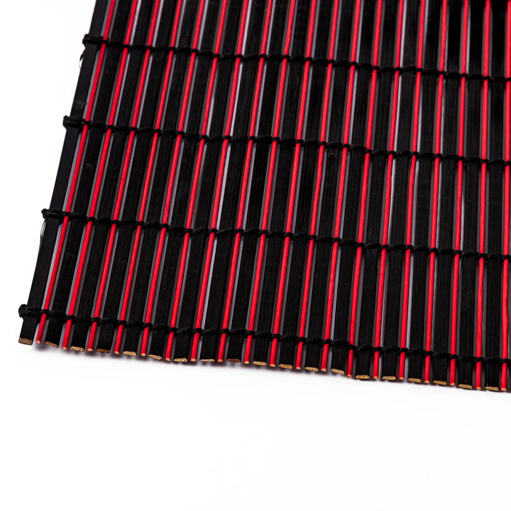 Red and black bamboo table mat with tightly spaced slats and black cord binding, adding bold color and texture to modern Japanese table settings.