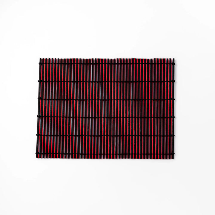 Red and black bamboo table mat with tightly spaced slats and black cord binding, adding bold color and texture to modern Japanese table settings.