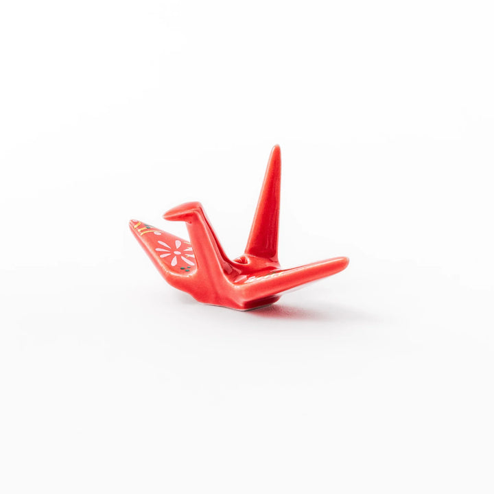 Red ceramic origami crane incense holder with delicate floral details, blending Japanese tradition and modern tableware design