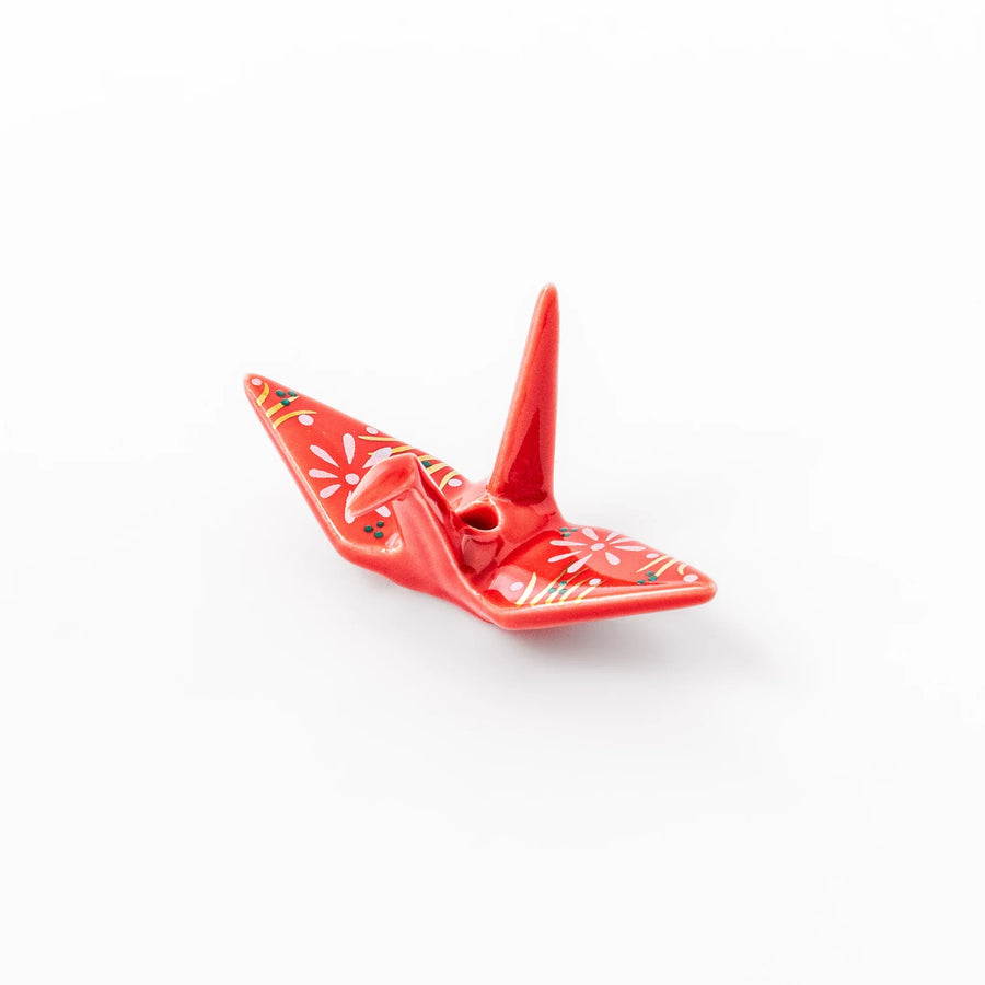 Red ceramic origami crane incense holder with delicate floral details, blending Japanese tradition and modern tableware design