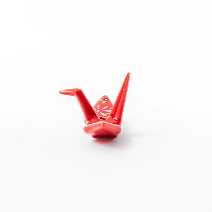 Red ceramic origami crane incense holder with delicate floral details, blending Japanese tradition and modern tableware design