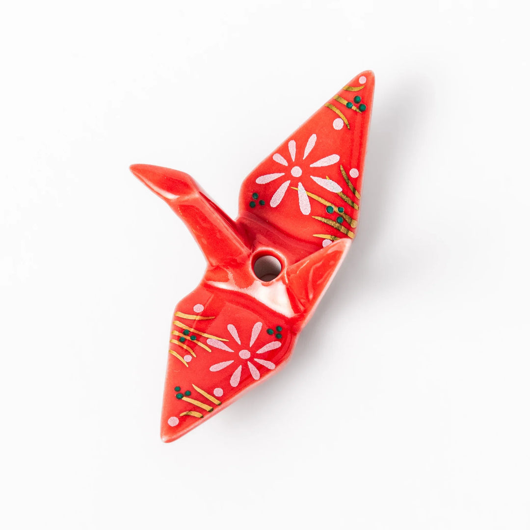 Red ceramic origami crane incense holder with delicate floral details, blending Japanese tradition and modern tableware design