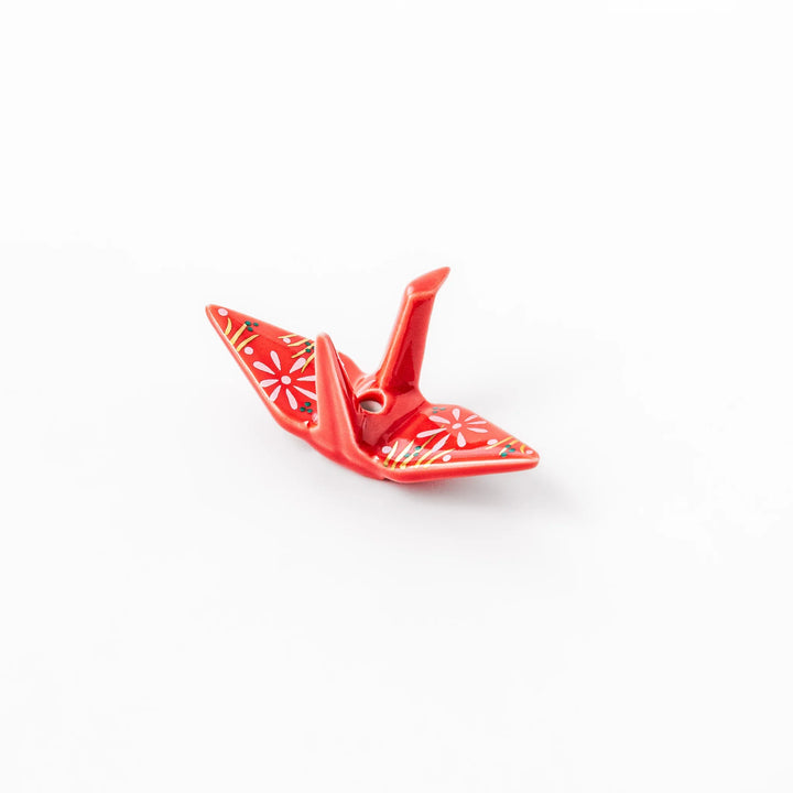 Red ceramic origami crane incense holder with delicate floral details, blending Japanese tradition and modern tableware design