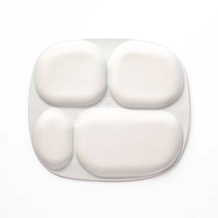 White ceramic kids plate with police car, airplane, fire truck, and rocket motifs in divided sections