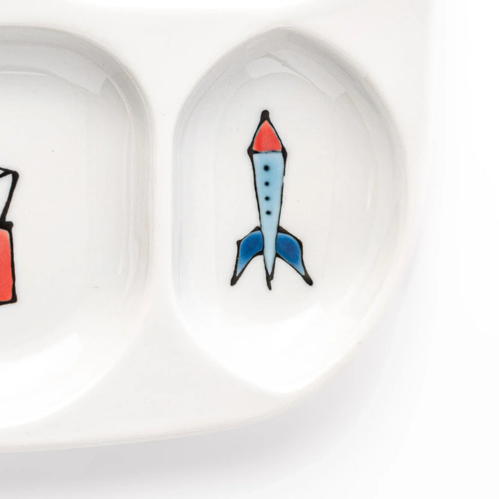 White ceramic kids plate with police car, airplane, fire truck, and rocket motifs in divided sections