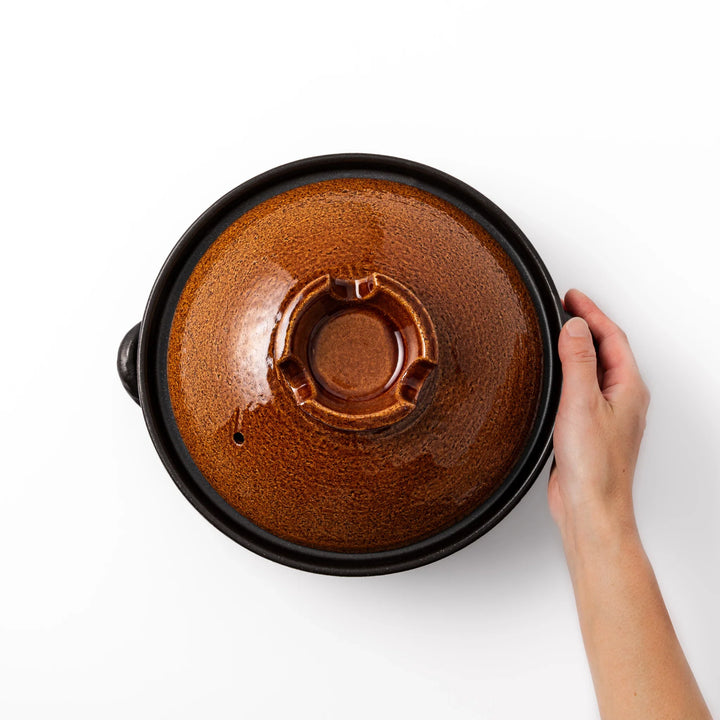 Japanese donabe clay pot with rustic brown glazed lid and black base, induction compatible and ideal for 2–3 person hot pot meals