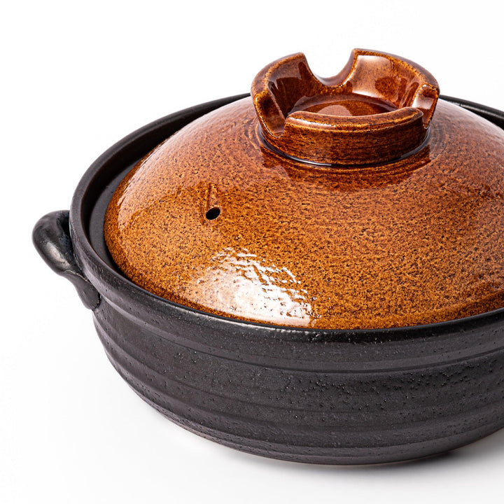 Japanese donabe clay pot with rustic brown glazed lid and black base, induction compatible and ideal for 2–3 person hot pot meals