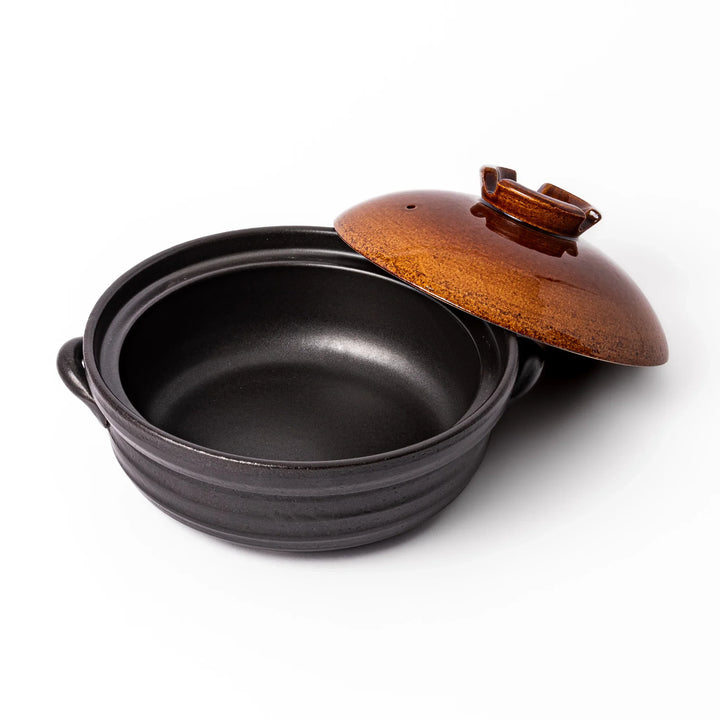 Japanese donabe clay pot with rustic brown glazed lid and black base, induction compatible and perfect for family hot pot meals.