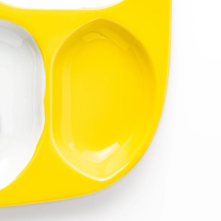 White ceramic kids divided plate with smiling yellow giraffe, tree and bird motifs, vibrant yellow sections