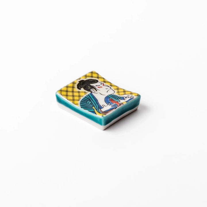 Rectangular Japanese ceramic chopstick rest featuring a bold kabuki actor design inspired by Sharaku’s ukiyo-e, adding dramatic artistry to dining tables.