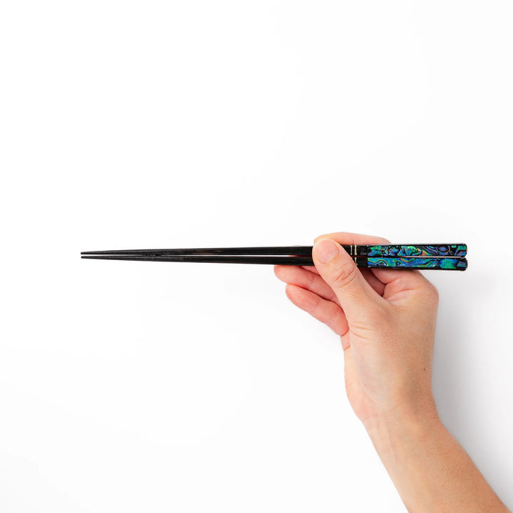 Japanese black lacquer chopsticks with shimmering abalone shell inlay, handcrafted for refined and elegant dining.