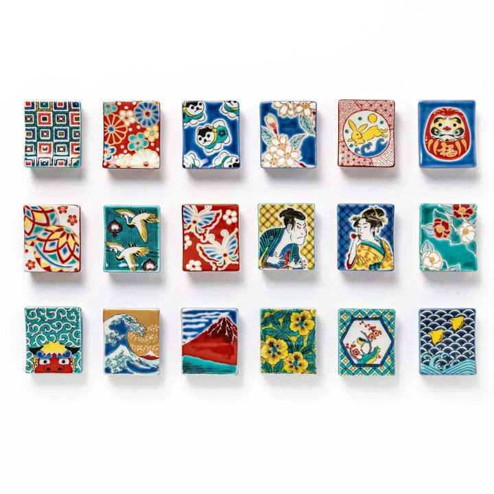 Collection of Japanese ceramic chopstick rests featuring diverse traditional motifs including waves, Mt. Fuji, florals, ukiyo-e figures, animals, and lucky symbols.