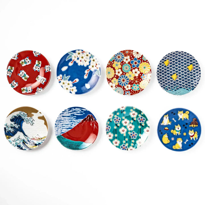 Set of round Japanese ceramic sauce dishes featuring traditional motifs such as waves, Mt. Fuji, cherry blossoms, maneki neko, and playful shiba dogs.
