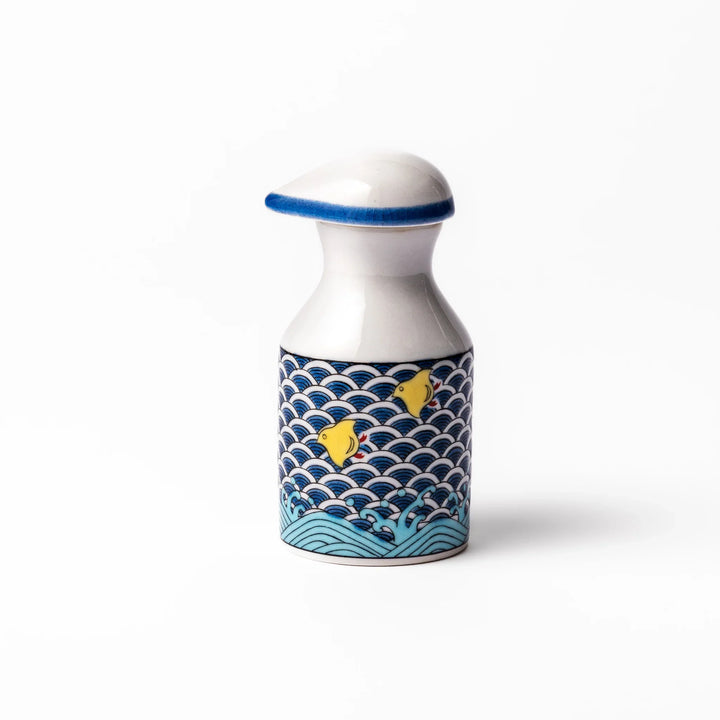Japanese ceramic soy sauce dispenser featuring a blue wave pattern with yellow shorebirds, combining traditional design and playful detail for table use.
