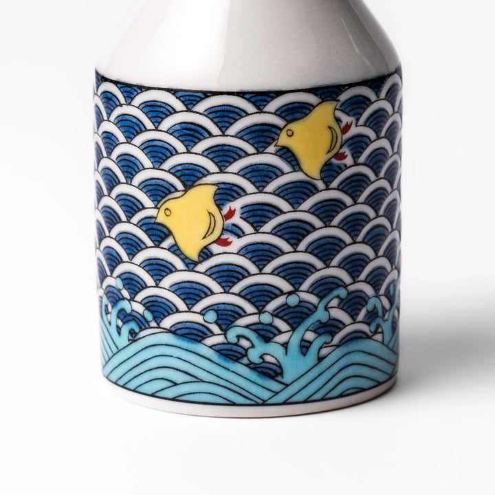 Japanese ceramic soy sauce dispenser featuring a blue wave pattern with yellow shorebirds, combining traditional design and playful detail for table use.