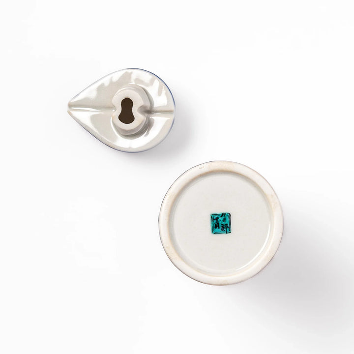 Japanese ceramic soy sauce dispenser featuring a blue wave pattern with yellow shorebirds, combining traditional design and playful detail for table use.