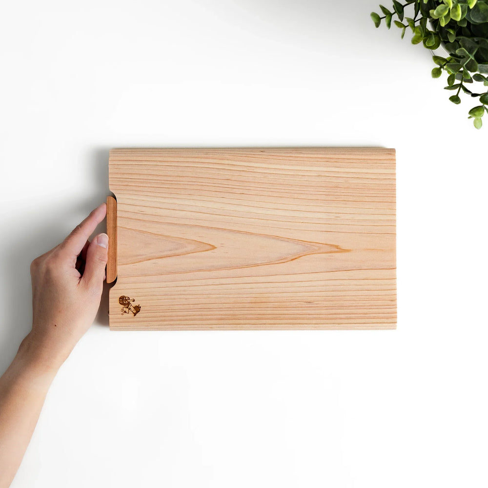 Small Hinoki wood cutting board with smooth grain, natural finish, corner handle, and engraved motif, crafted in Japan