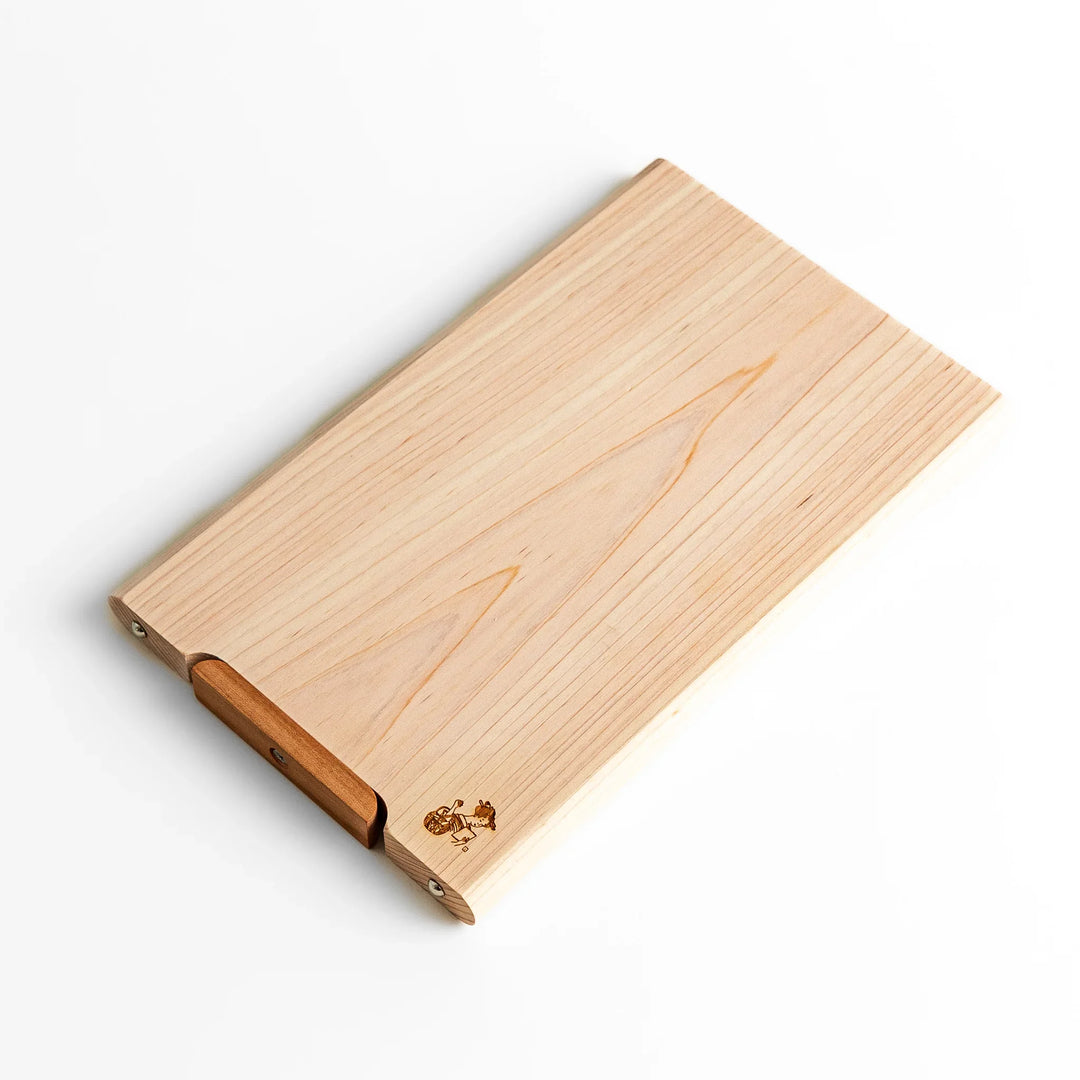 Small Hinoki wood cutting board with smooth grain, natural finish, corner handle, and engraved motif, crafted in Japan