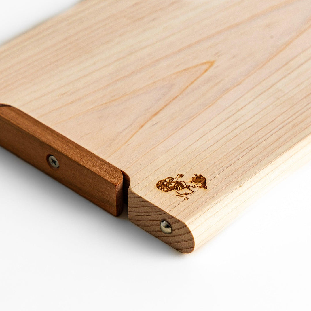 Small Hinoki wood cutting board with smooth grain, natural finish, corner handle, and engraved motif, crafted in Japan