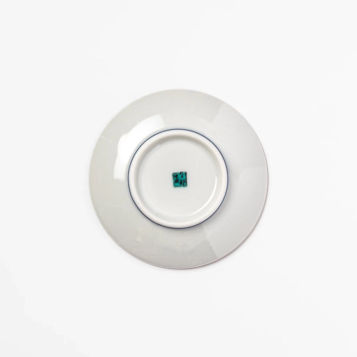 Round Japanese ceramic sauce dish with teal background, decorated with white and blue plum blossom motifs, perfect for serving condiments or small bites.