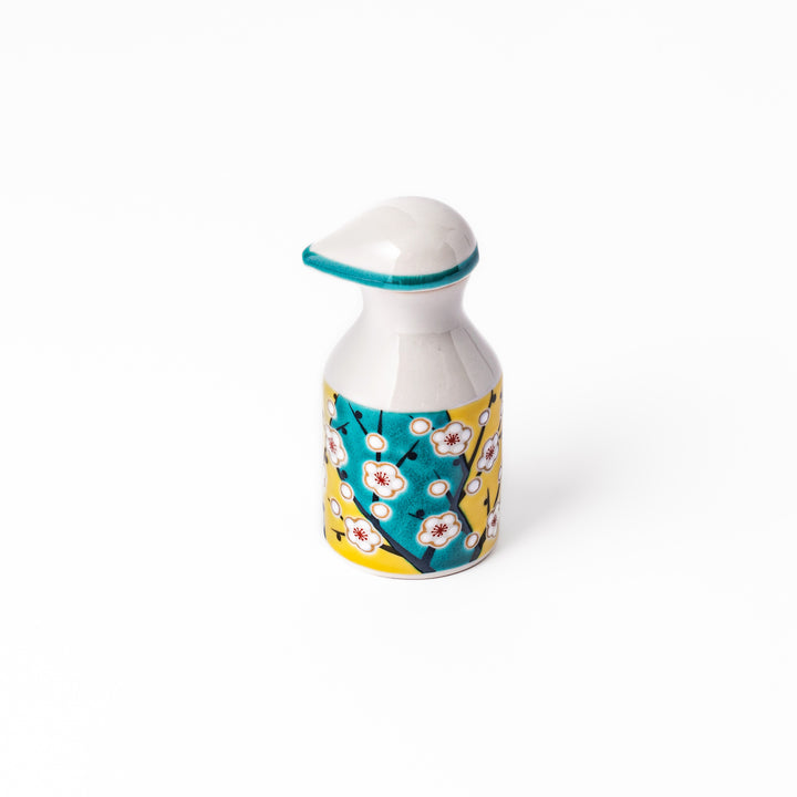 Japanese ceramic soy sauce dispenser with a teal lid and yellow body featuring white plum blossom motifs, handcrafted in Arita Japan.