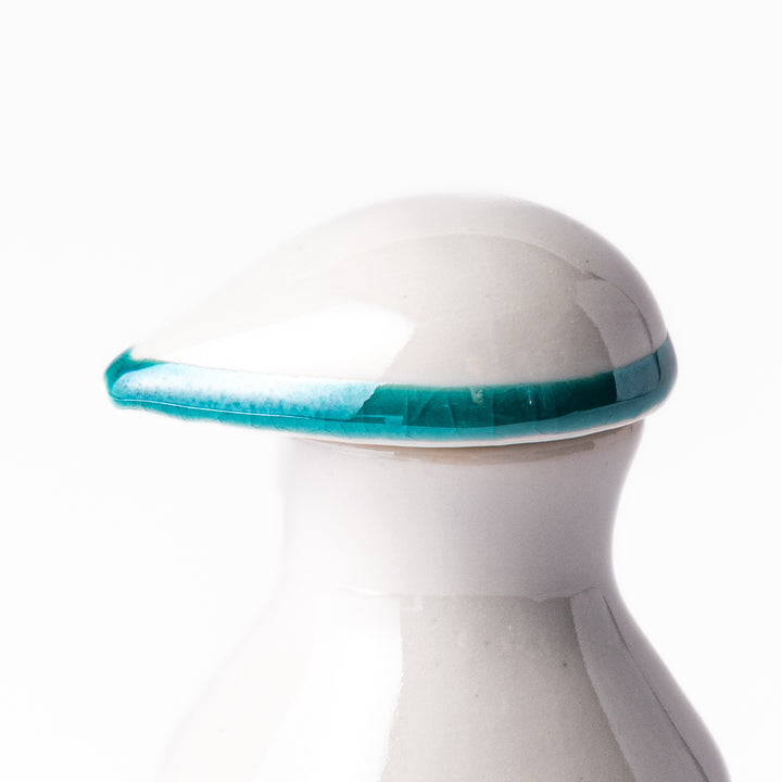 Japanese ceramic soy sauce dispenser with a teal lid and yellow body featuring white plum blossom motifs, handcrafted in Arita Japan.