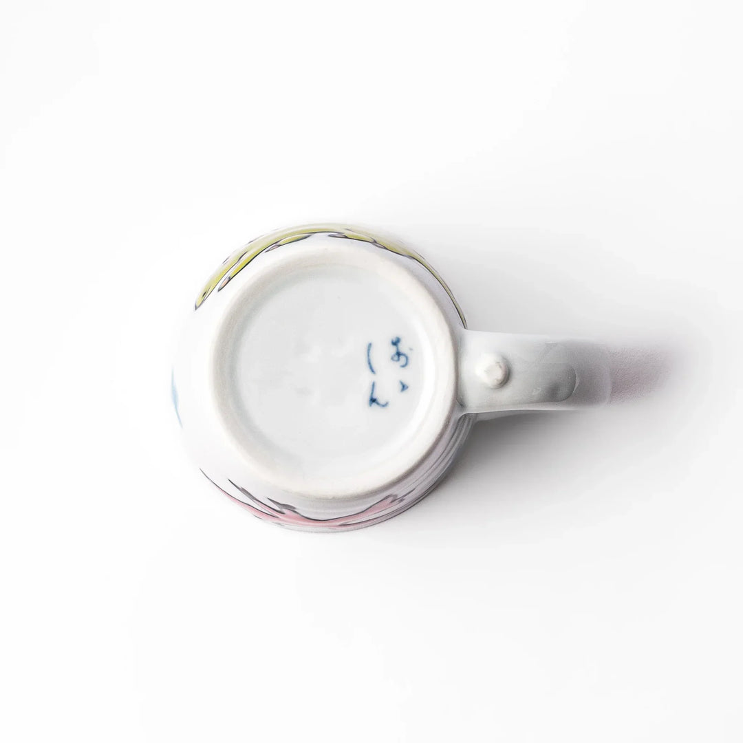 White ceramic kids mug featuring green stegosaurus dinosaur with round handle, shown on white background