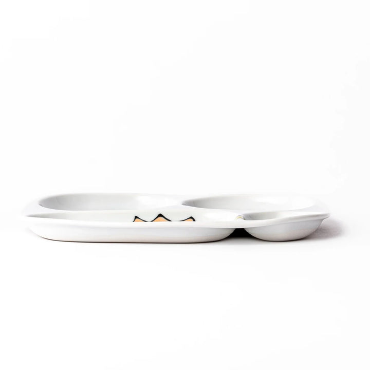 White ceramic kids divided plate with green stegosaurus, red erupting volcano, pink pterodactyl and blue cloud motifs