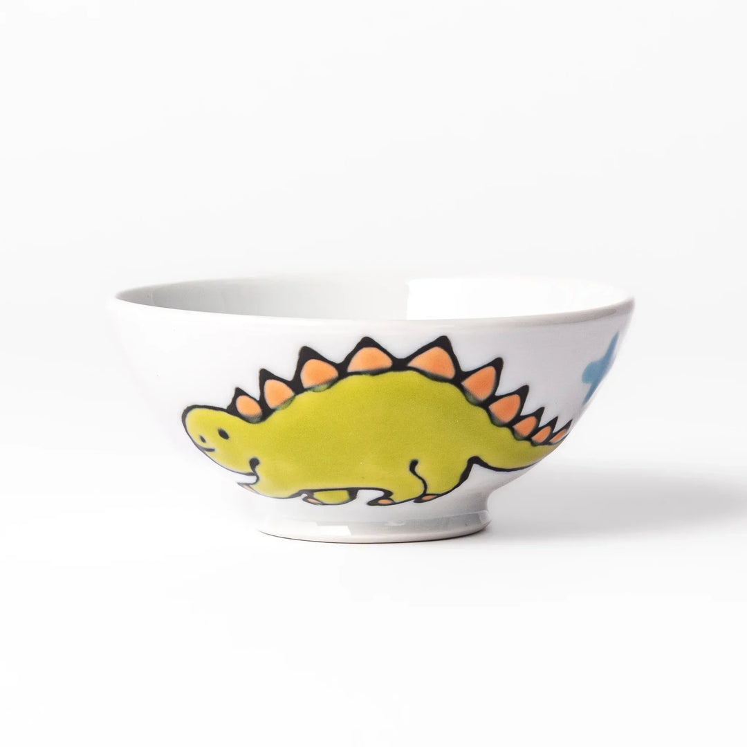 White ceramic kids rice bowl with green stegosaurus dinosaur motif and blue cloud accents