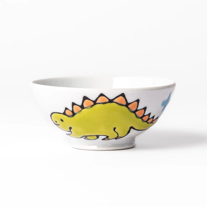 White ceramic kids rice bowl with green stegosaurus dinosaur motif and blue cloud accents