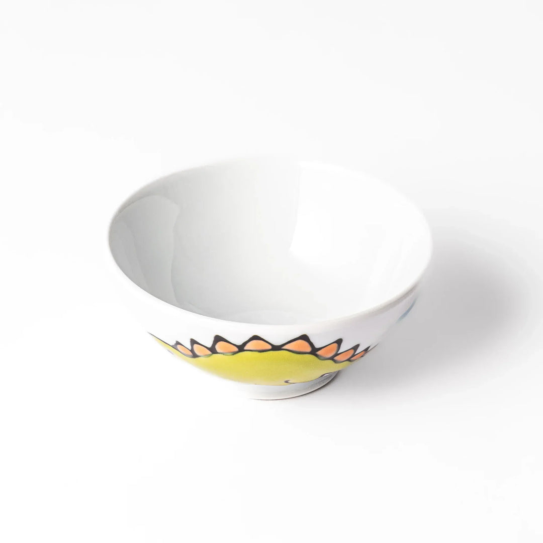 White ceramic kids rice bowl with green stegosaurus dinosaur motif and blue cloud accents