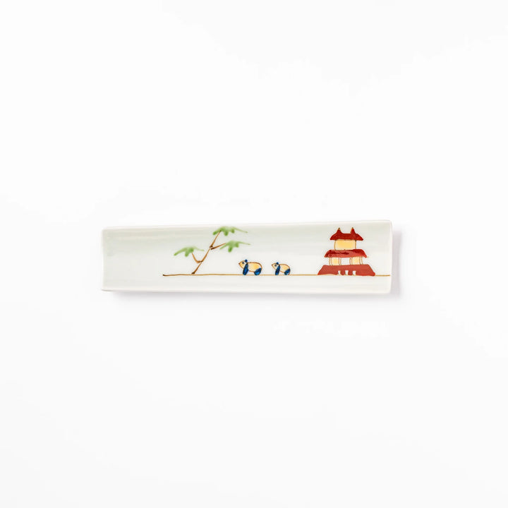 Japanese porcelain chopstick rest with whimsical China design featuring red pagoda, pandas, bamboo, and green tree accents