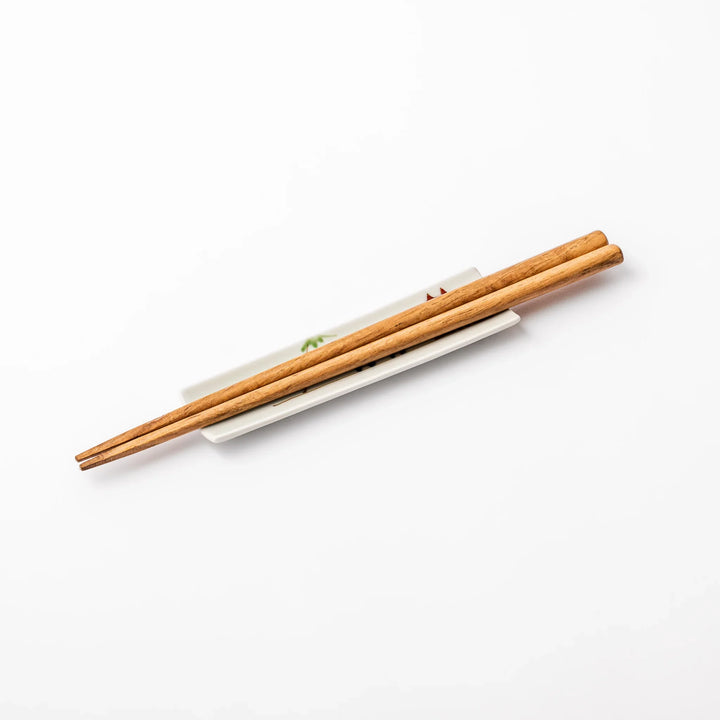 Japanese porcelain chopstick rest with whimsical China design featuring red pagoda, pandas, bamboo, and green tree accents