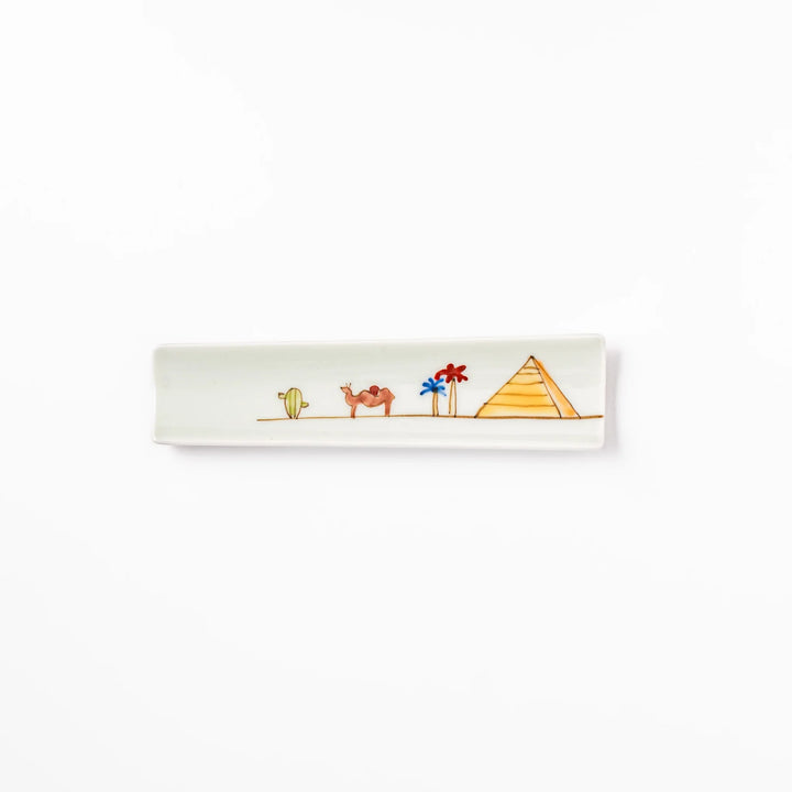 Japanese porcelain chopstick rest with whimsical Egypt design featuring pyramid, camel, cactus, and colorful palm trees