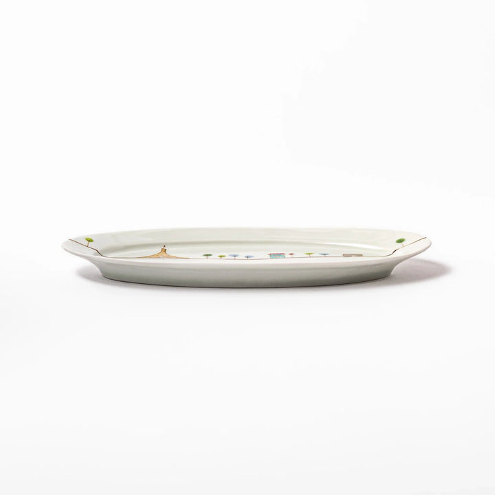 Japanese porcelain oval plate with whimsical France design featuring Eiffel Tower, Arc de Triomphe, trees, and colorful house