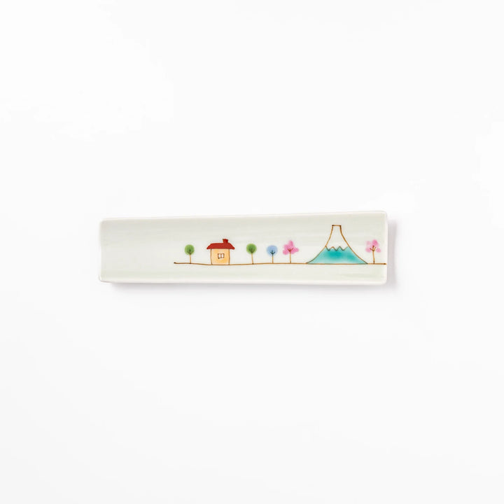 Japanese porcelain chopstick rest with whimsical Japan design featuring Mount Fuji, cherry blossoms, house, and colorful trees