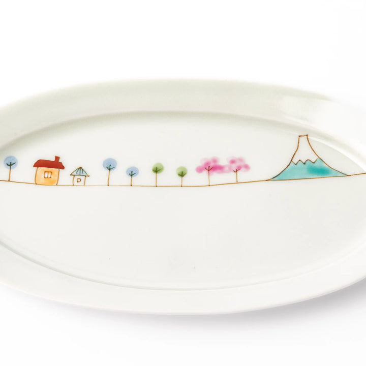 Japanese porcelain oval plate with whimsical Japan design featuring Mount Fuji, cherry blossoms, houses, and colorful trees