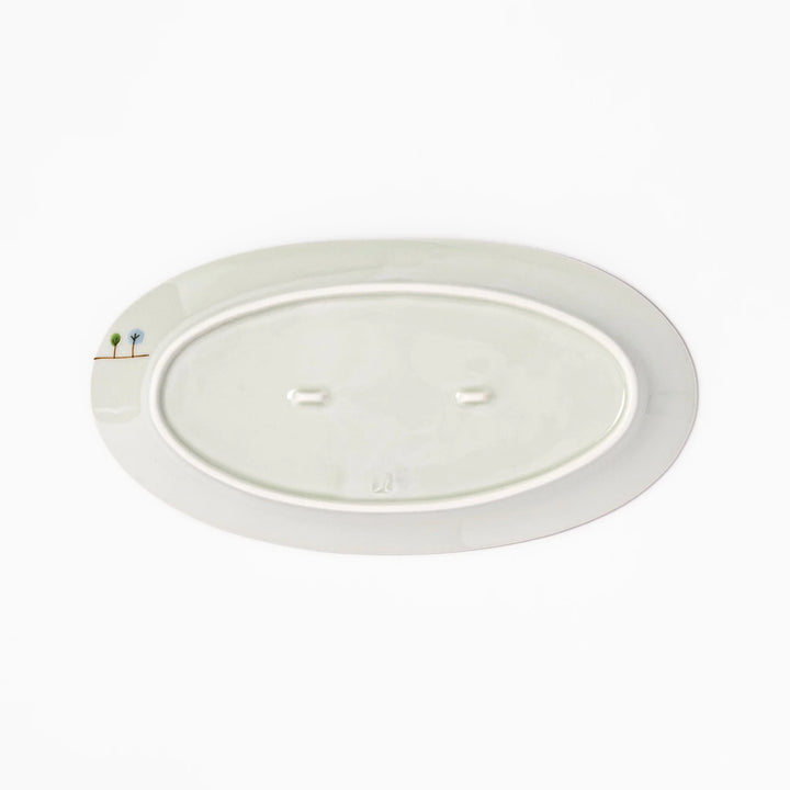 Japanese porcelain oval plate with whimsical Japan design featuring Mount Fuji, cherry blossoms, houses, and colorful trees