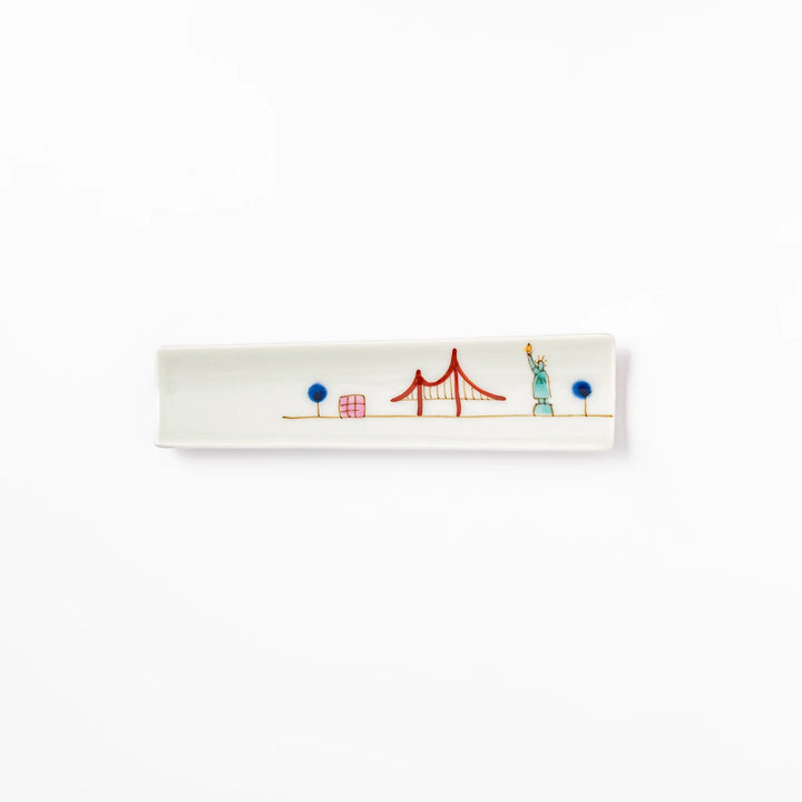 Japanese porcelain chopstick rest with USA design featuring Statue of Liberty, red bridge, and colorful cityscape accents