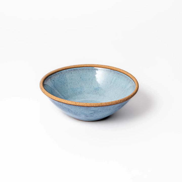 Terracotta blue ceramic cereal bowl with rustic brown rim, handcrafted in Japan for serving cereal, salad, soup, or everyday meals.