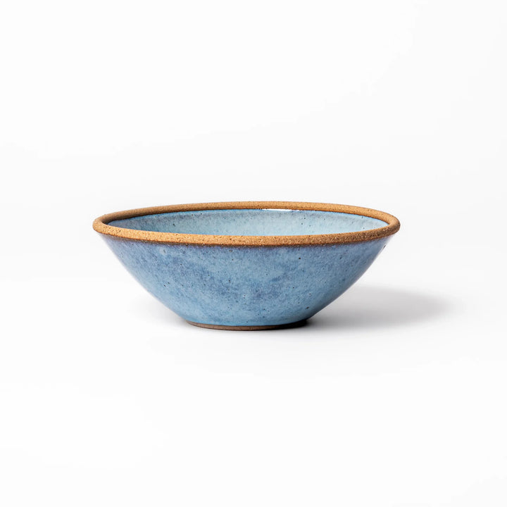 Terracotta blue ceramic cereal bowl with rustic brown rim, handcrafted in Japan for serving cereal, salad, soup, or everyday meals.