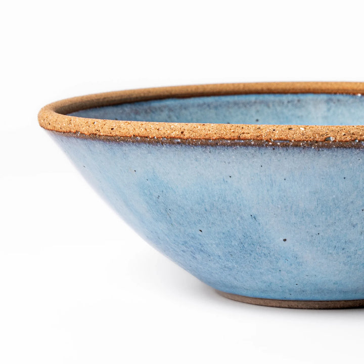 Terracotta blue ceramic cereal bowl with rustic brown rim, handcrafted in Japan for serving cereal, salad, soup, or everyday meals.