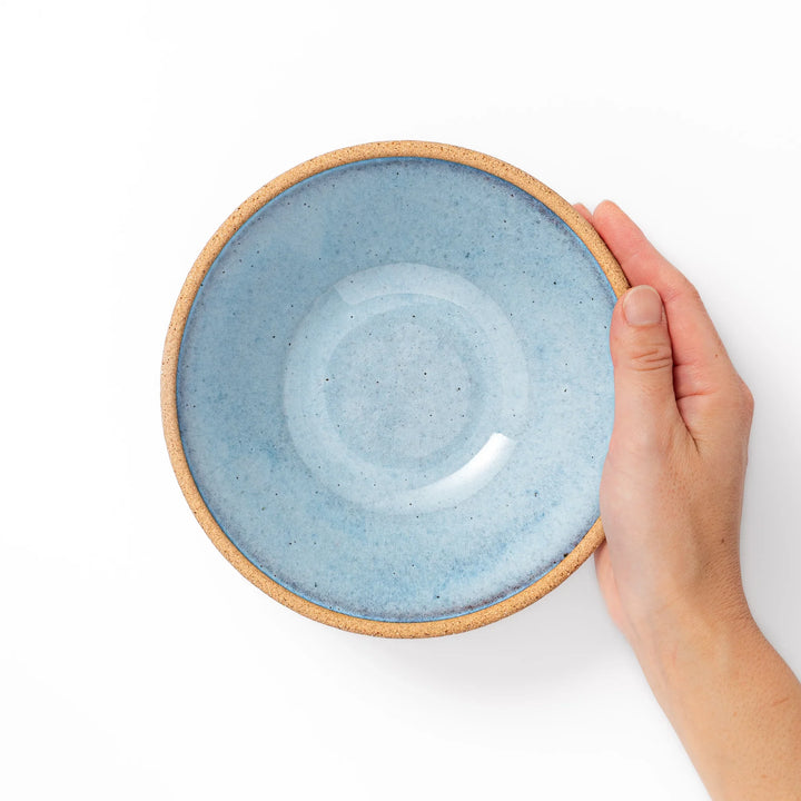 Terracotta blue ceramic cereal bowl with rustic brown rim, handcrafted in Japan for serving cereal, salad, soup, or everyday meals.