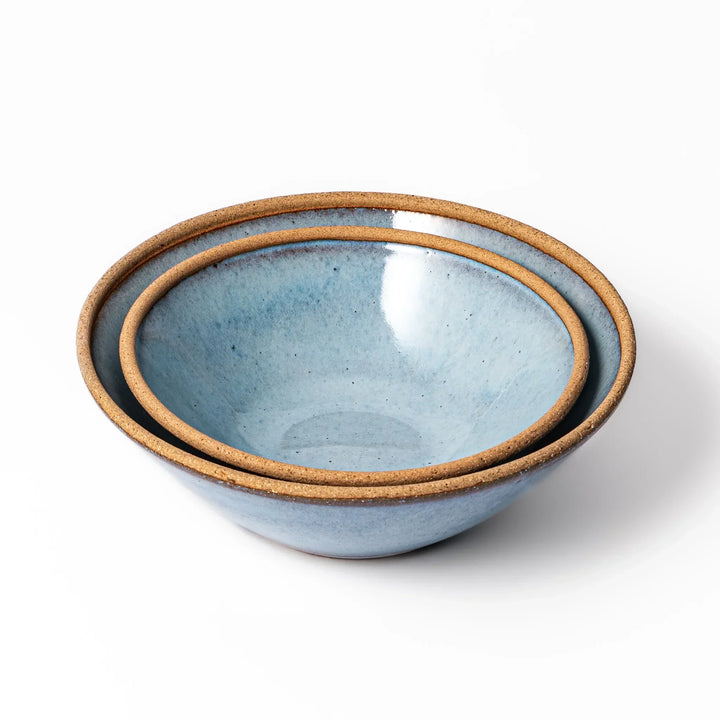 Two stackable terracotta blue ceramic bowls with rustic brown rim, handcrafted in Japan for cereal, salad, soup, and everyday meals.