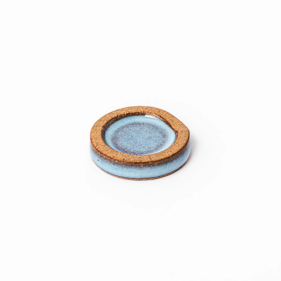 Terracotta blue ceramic chopstick rest with rustic brown rim, handcrafted in Japan to add an elegant accent to everyday dining.