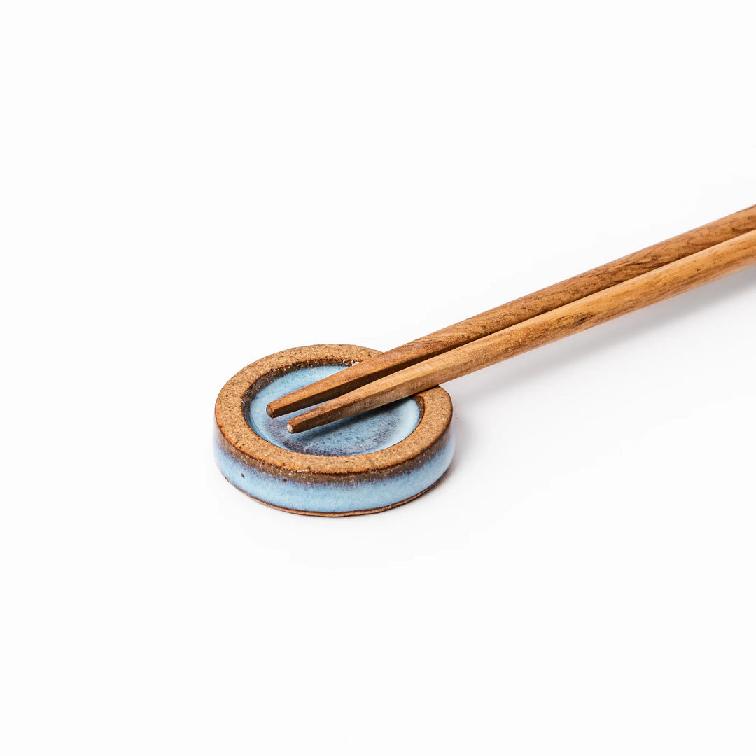 Terracotta blue ceramic chopstick rest with rustic brown rim, handcrafted in Japan to add an elegant accent to everyday dining.