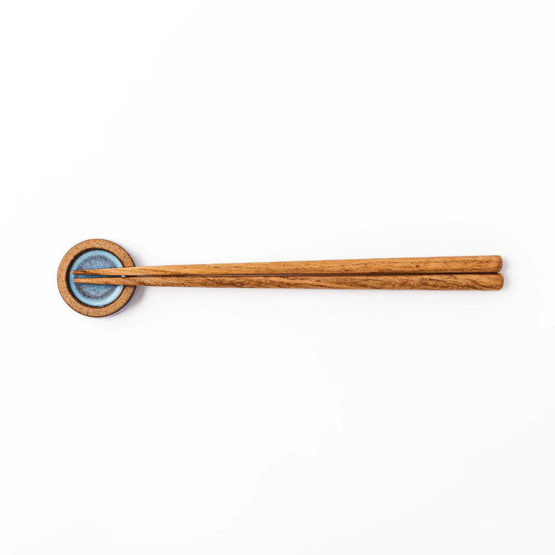 Terracotta blue ceramic chopstick rest with rustic brown rim, handcrafted in Japan to add an elegant accent to everyday dining.