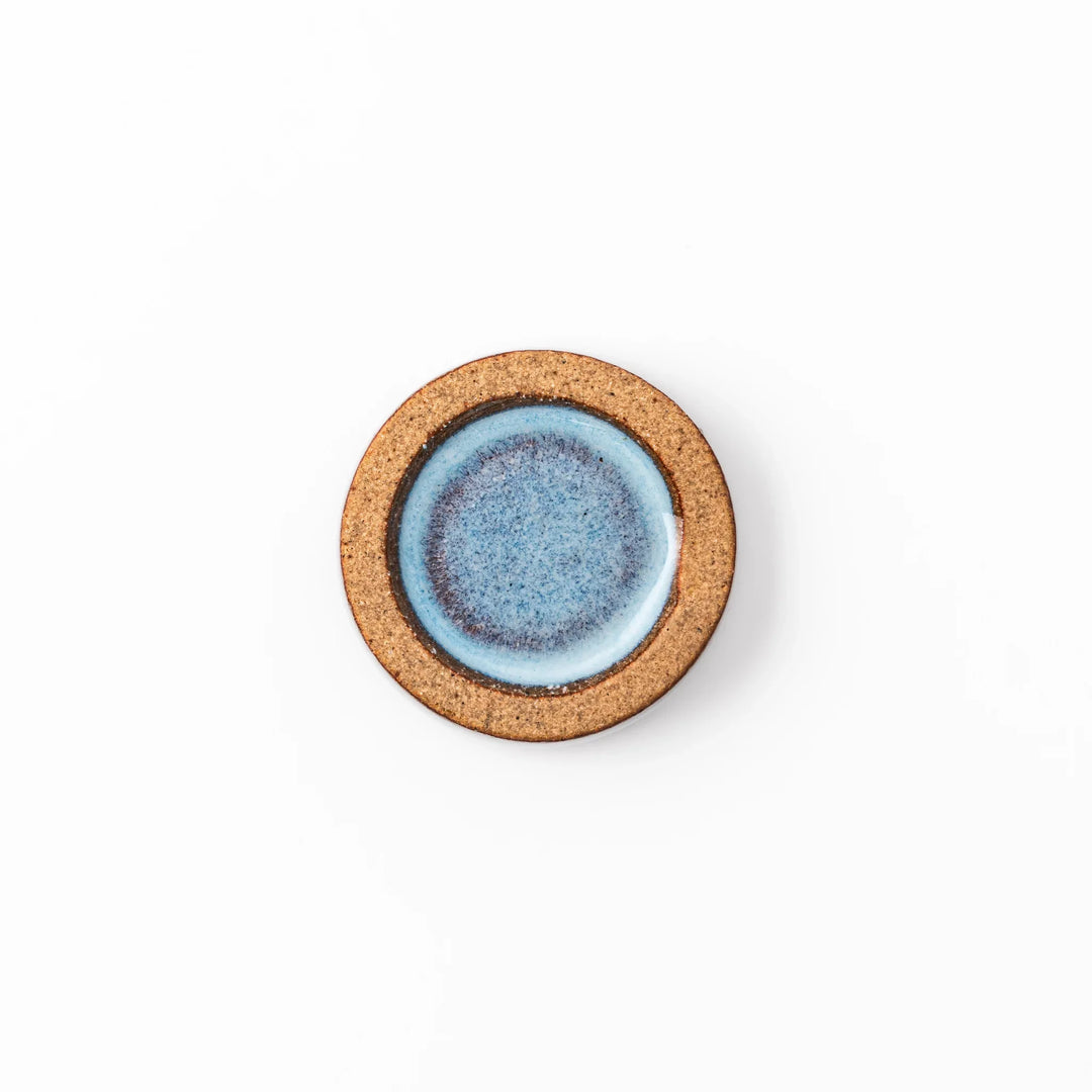 Terracotta blue ceramic chopstick rest with rustic brown rim, handcrafted in Japan to add an elegant accent to everyday dining.